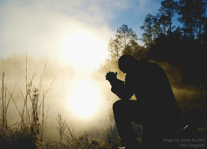 Man Kneeling in Prayer by Aaron Burden at Unsplash