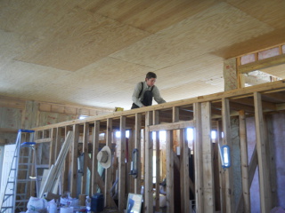 Robert Putting Plywood Down on Closet Ceiling