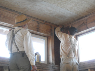 Fellowship Men Helping Put Up Corner Ceiling Panel