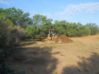 Backhoe Digging Inner Field Pond
