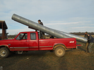 Unloading Culvert Pipe from Truck