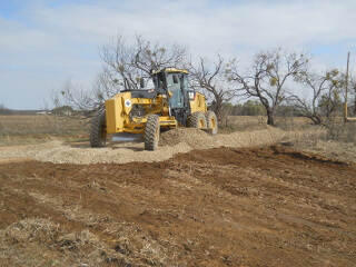 Scraping Road Base into Place