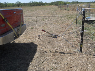Come-Along Hooked to Truck and Fence Puller