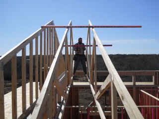 Standing Between Two House Roof Trusses