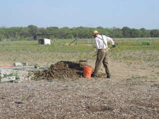 Retrieving Dirt to Mix into the Concrete